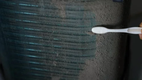 Close-up of a hand using a cotton swab to clean or test a dark textured sur.. Vídeo Stock 338319339