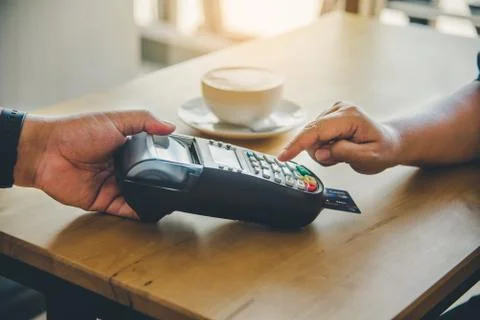 Close up of hand using credit card to pay by sending the credit card to the s Stock Photos
