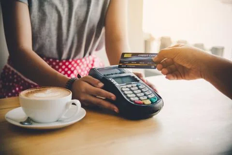 Close up of hand using credit card to pay by sending the credit card to the s Stock Photos