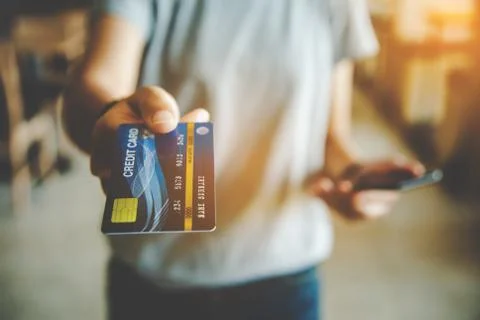 Close up of hand using credit card to pay by sending the credit card Stock Photos