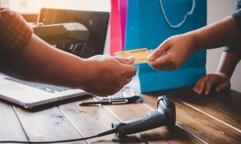 Close up of hand using credit card to pay by sending the credit card to the s Stock Photos