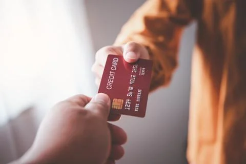 Close up of hand using credit card to pay by sending the credit card to the s Stock Photos