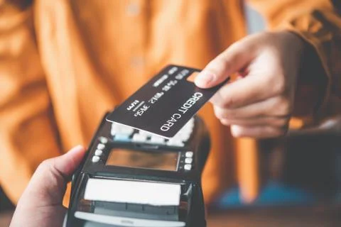 Close up of hand using credit card to pay by sending the credit card to the s Stock-Fotos