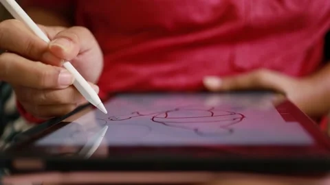 Close-up hand using digital pen drawing on computer tablet Stock Footage 167786039