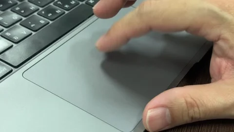 Close-Up of Hand Using Finger to Click and Scroll on a Laptop Trackpad Stock Footage 324558591