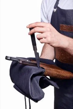 Close up of hand using, holding cooking knives. chef uniform in back, unrecog Stock Photos