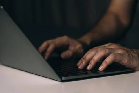 Close up hand using laptop computer on desk. Stock Photos