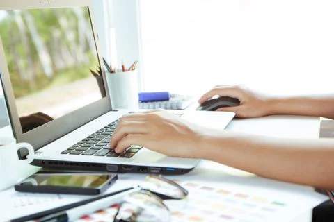Close up hand using laptop on desk Stock Photos