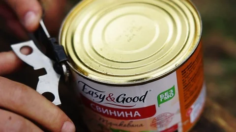 Close up of a hand using a manual can opener Stock Footage 113280593