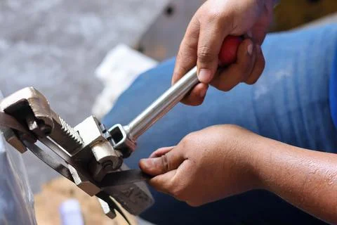 Close up hand using manual strapping of packages for shipping Stock Photos