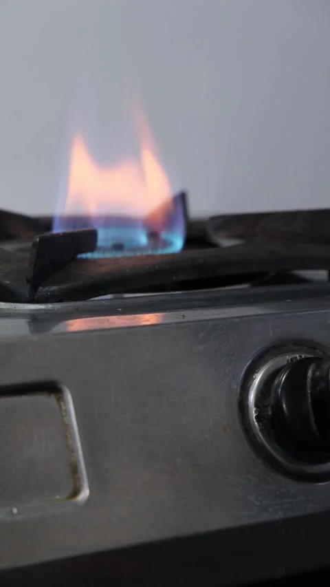 Close up of hand using metal lighter to ignite gas stove burner in kitchen 스톡 동영상 331898818