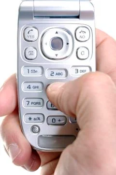Close up of hand using mobile phone keypad to send text messages Stock-Fotos