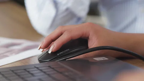 Close-up of a hand using a mouse connected to a laptop Stock-Footage 342472983