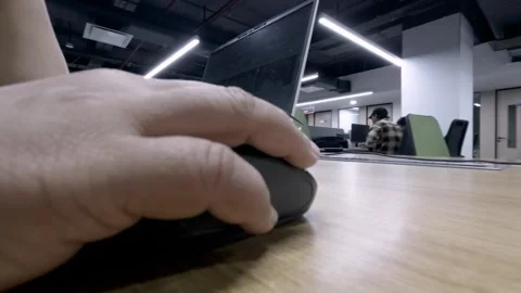 Close-Up of Hand Using Mouse on Wooden Office Table with Multiple Chairs Stock Footage 310035253
