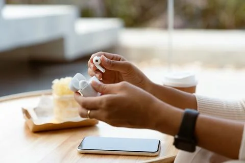 Close-up hand using new earbuds Stock Photos