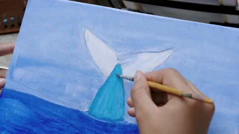 Close-up hand using paintbrush paint blue watercolor on canvas for painting.. Stock Footage 243708558
