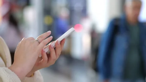 Close-up of hand using phone in crowded indoor setting Stock Footage 345674651
