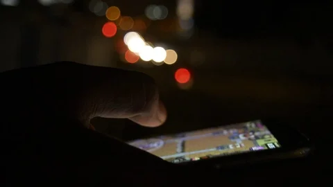 Close-up hand using phone in night time on street Видео 81763641