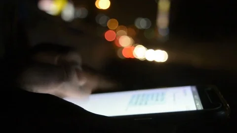 Close-up hand using phone in night time on street Видео 81763941