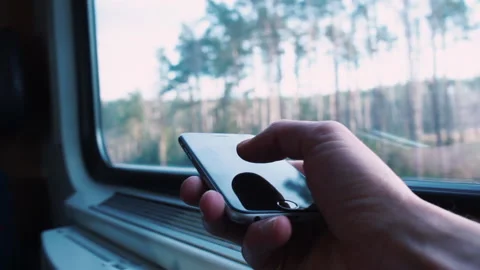 Close-up hand using phone public transport waxing window finger presses screen, Stock Footage 144843313
