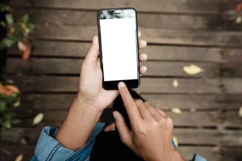 Close-up on hand using phone walking on road top view Stock Photos