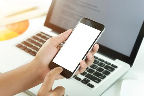 Close up hand using phone white screen on workspace table Stock Photos