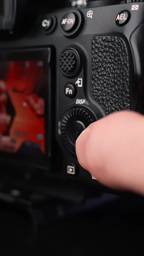 Close-up of hand using rear control wheel to browse image playback on digital Stock Footage 331318407