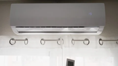 Close-up of hand using remote control to turn on air conditioner, activatin.. Stock Footage 342762701