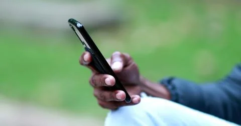 Close-up hand using smartphone, african black person checking cellphone out.. Stock Photos