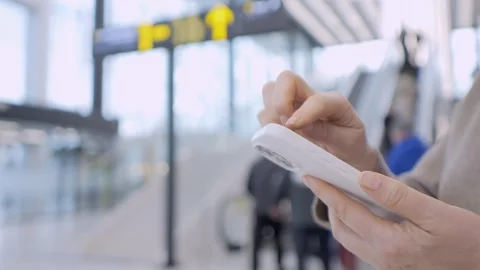 Close-up of hand using smartphone in busy airport Stock Footage 340967351