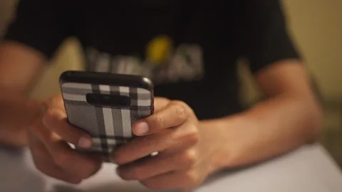 Close Up of Hand Using Smartphone Indoors Stock Footage 344235796