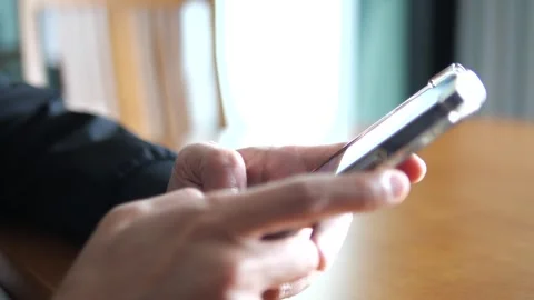 Close Up Hand Using Smartphone in Modern Indoor Setting with Soft Light Stock Footage 325236743