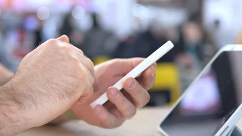 Close-up of hand using smartphone in public setting Stock Footage 342028449