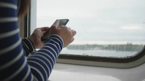 Close up hand using smartphone by the window, sliding screen on smartphone 스톡 동영상 180039072