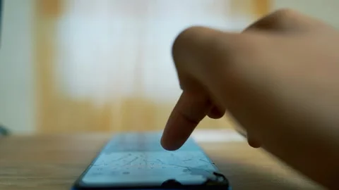 Close-up of a hand using a smartphone on a wooden table Stock Footage 315981202