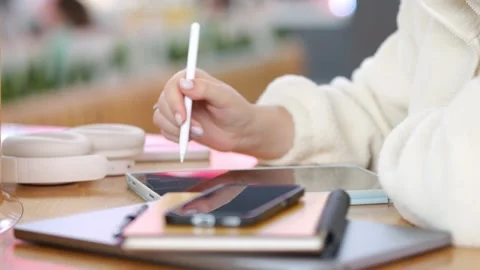 Close-up of hand using stylus on digital tablet Stock Footage 347928643
