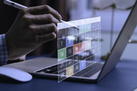 Close-up of hand using stylus with digital calendar interface on laptop, re.. Stock Photos