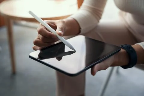 Close-up hand using stylus pen on digital tablet Stock Photos