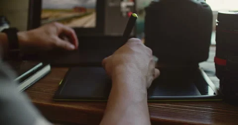 Close-Up of Hand Using Stylus on Tablet at Wooden Desk 動画素材 308378006