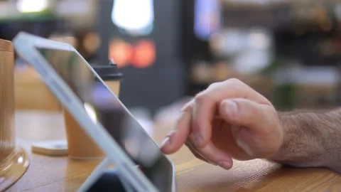 Close-up of hand using tablet in casual indoor space 스톡 동영상 341073318