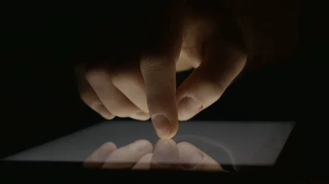 Close-up of hand using tablet pc in the dark Stock Footage 58959971