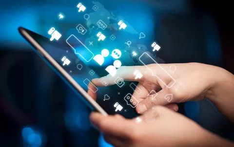 Close-up of a hand using tablet, social media concept Stock Photos