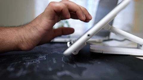 Close-up of a hand using a tablet on a stand, blurred background Stock Footage 318056735
