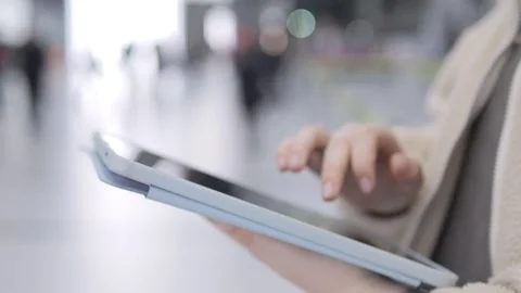 Close-up of hand using tablet in transit area Stock Footage 342588783
