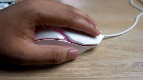 Close-up of a hand using a white computer mouse on a wooden desk Stock Footage 315981403