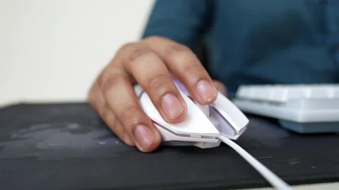 Close-up of a hand using a white computer mouse on a black mouse pad Stock Footage 318057136