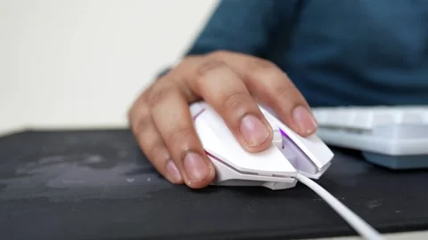 Close-up of a hand using a white computer mouse on a black mouse pad Stock Footage 318057140