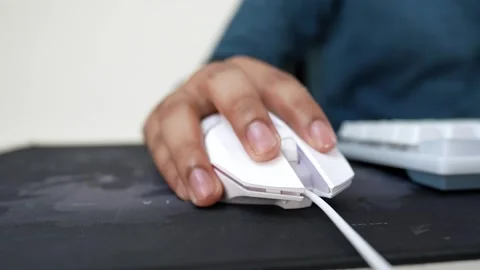 Close-up of a hand using a white computer mouse on a black mouse pad Stock Footage 318057144