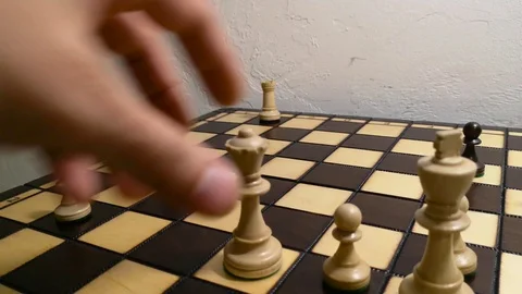 Close up hand using white queen checkmate the black king Stock Footage 112946796