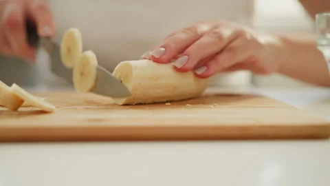 Close Up Hand View Of Cook Slicing Banana Into Tiny Round Shape 動画素材 307981979